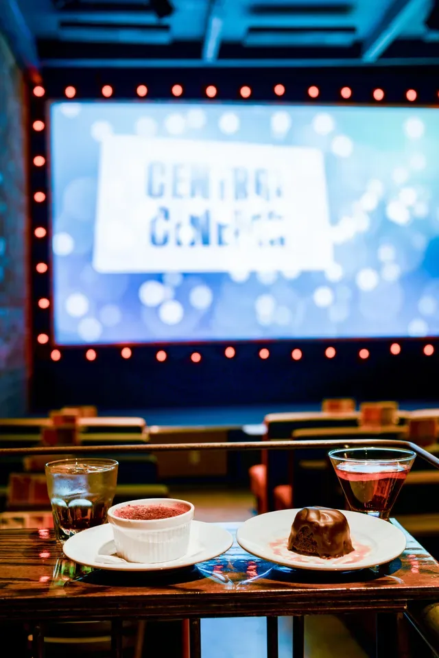A film screening inside Central Cinema with food and drinks set at a table.