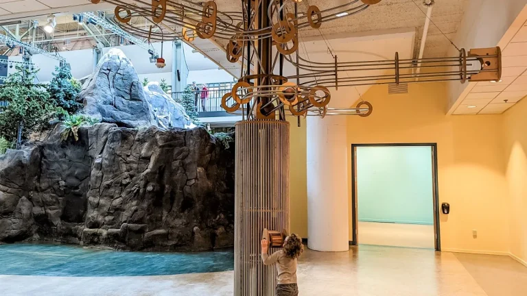 A child explores a kinetic sculpture inside Seattle Children’s Museum.