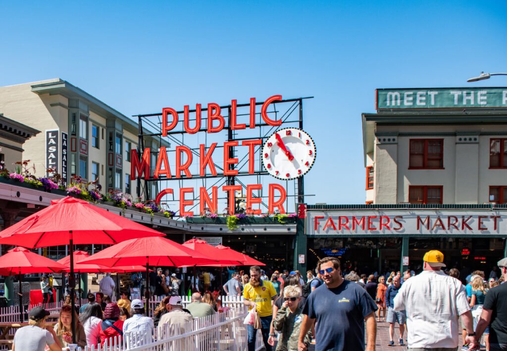 The iconic red Pike Place Market sign and Public Market Center clock at the main entrance is one of Seattle's Must-See pPlaces. This is the top tourist spot in Downtown Seattle.
