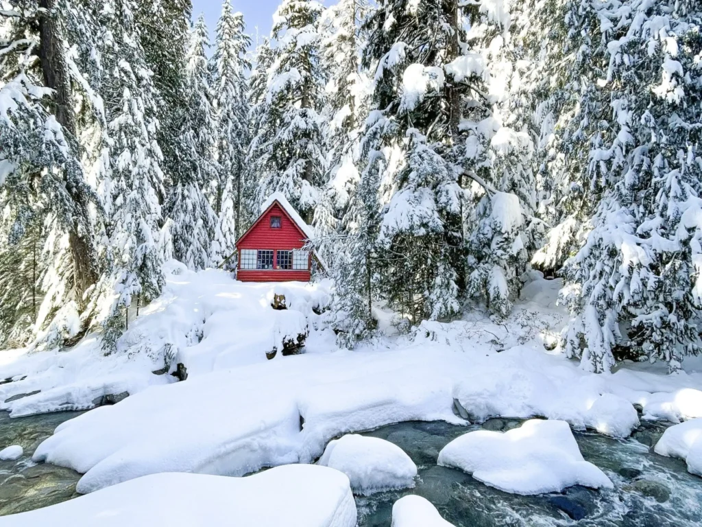 A red cabin at the foothills of the frozen Franklin Falls lake renders the place a true winter wonderland.